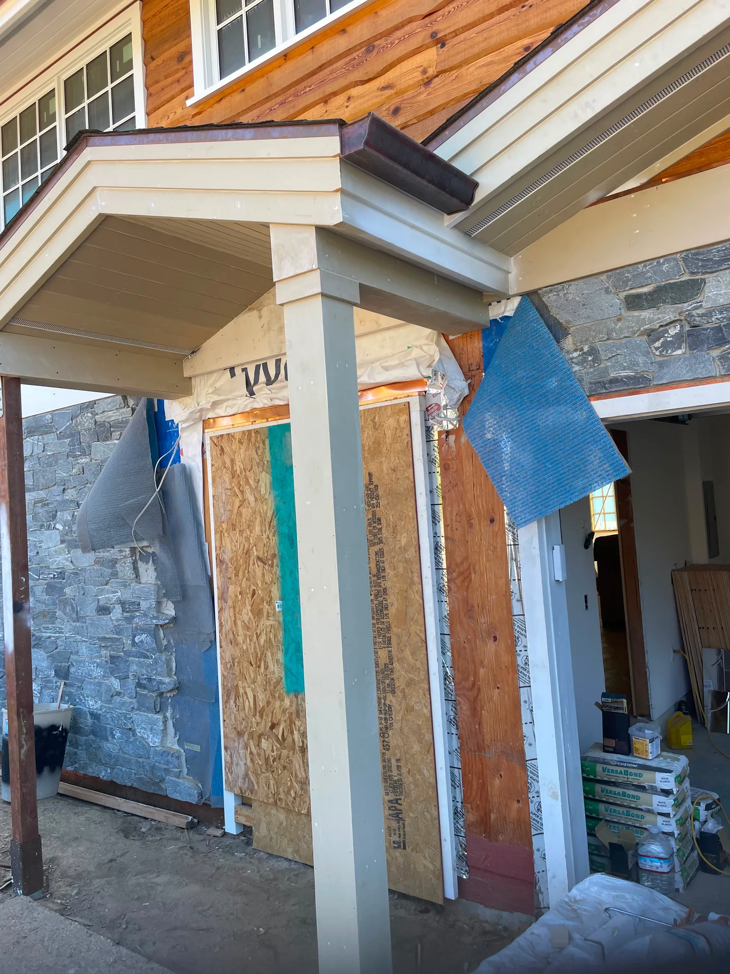 Finished exterior porch entry with stonework